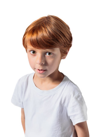 Red-haired boy in white t-shirt close-up cropped view at gray backgroundの写真素材