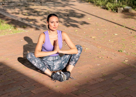 Fit woman exercising outdoors. Healthy young female athlete doing fitness workout.の写真素材