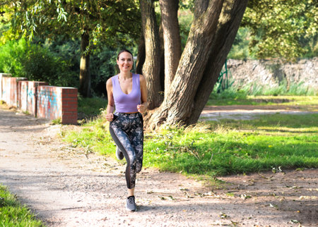 Fit woman exercising outdoors. Healthy young female athlete doing fitness workout.の写真素材