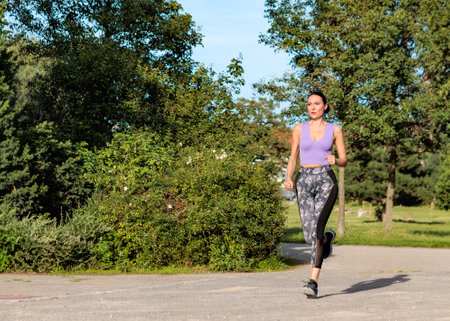 Fit woman exercising outdoors. Healthy young female athlete doing fitness workout.の写真素材