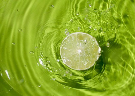 green lemon on water splash backgroundの写真素材