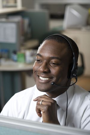 Businessman talking on headsetの写真素材