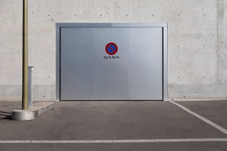 garage door parking prohibited sign day and night with white parking spaceの写真素材