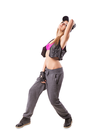 Modern urban girl standing on isolated background. Hip-hop go-go dance girl on whiteの写真素材