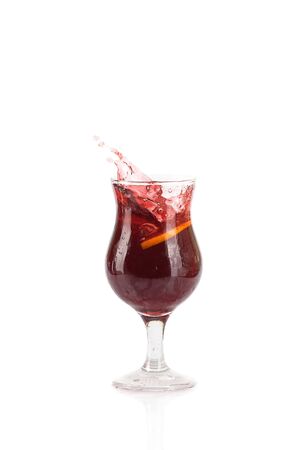 Summer exotic cocktail with ice, lemon and splashes on isolated white backgroundの写真素材