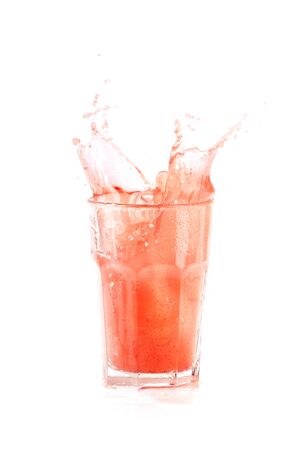 Summer exotic cocktail with ice, lemon and splashes on isolated white backgroundの写真素材