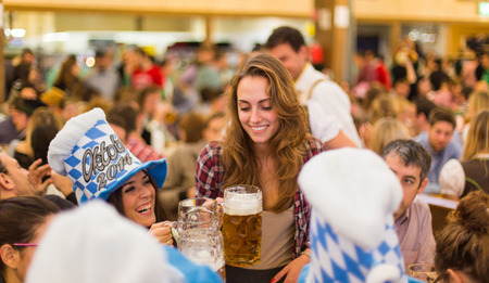 young girls toast with Oktoberfest beerのeditorial素材