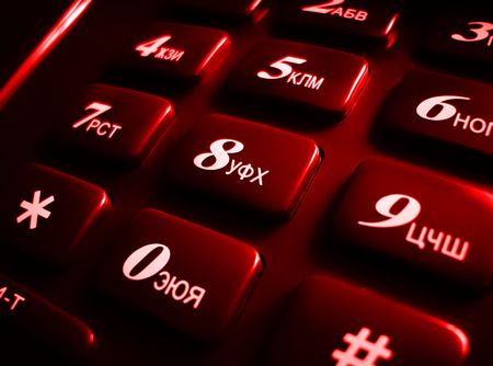 The dark red buttons on phone with cyrillic symbols and numbersの写真素材