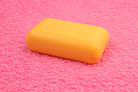 Yellow soap on the pink fluffy towerの写真素材