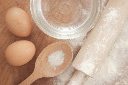 Bakery cooking tools and ingredients on wooden backgroundの写真素材