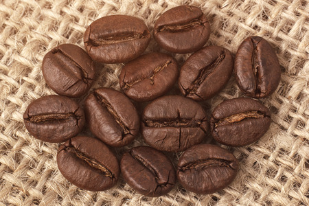 Macro of coffee beans on sackclothの写真素材