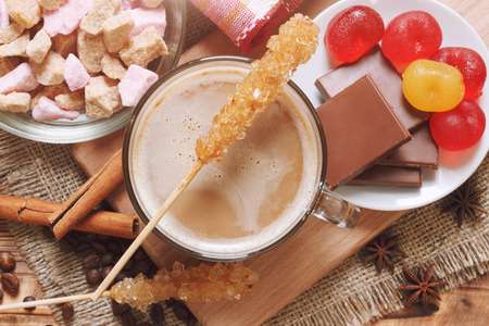 Crystal sugar sticks with cocoa hot drink and sweetsの写真素材