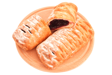 Puffy pies with blueberry jam filling isolated on whiteの写真素材