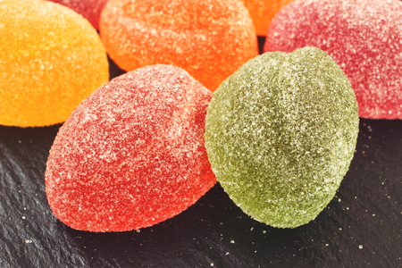 Marmalade sugar coated candies closeup on black background, top viewの写真素材