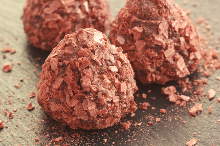 Truffle chocolate pralines candy coated with cracked waffle crumbs, selective focusの写真素材
