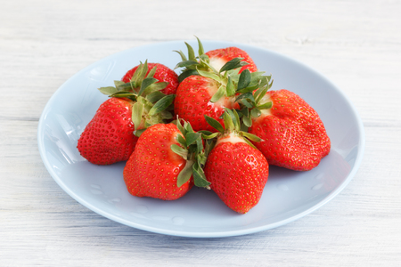 Fresh strawberry on plate. Red ripe berries on table.の写真素材