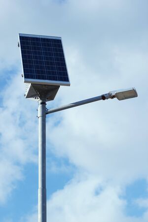 Pillar with electric solar panel and street lighting lamp system. Modern street equipment with renewable energy save technology.の写真素材