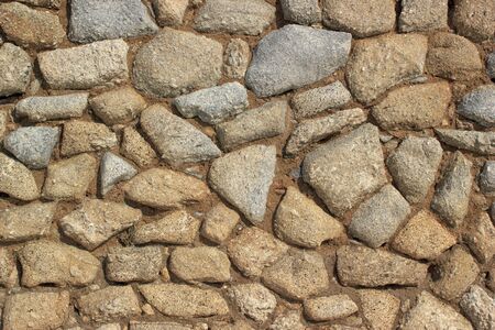 Vintage stone wall background. Stonework masonry closeup details.の写真素材