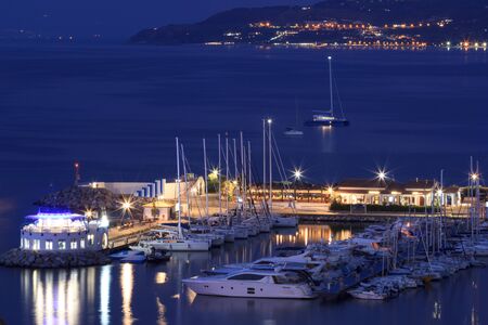 Tropea, Italy - September 6, 2019: Night illumination of Tropea town of South Italy. View at yacht port of Tropea with night lights and seaのeditorial素材