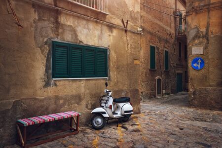 Tropea, Italy - September 7, 2019: Scooter on Southern Italy city. Old town narrow street with ancient walls and stone pavement.のeditorial素材