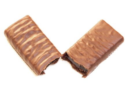 Two halves of brownie chocolate coated bar. Sweet snack food cake with fruit jelly filling inside.の写真素材