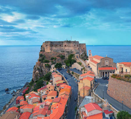 Scilla, Italy - September 7, 2019: View on Ruffo Castle and town roofs with road. Old ancient town settlement, top viewpoint from center.のeditorial素材
