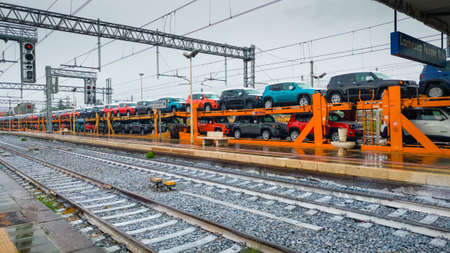 Lamezia Terme, Italy - September 4, 2019: The freight train transport with many of newly produced cars on the railway stationのeditorial素材