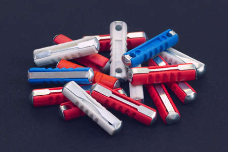 Heap of automotive electrical fuses with 8A, 16A and 25A current ratings.の写真素材