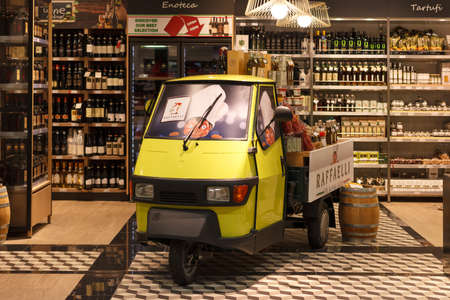 Fiumicino, Italy - September 09, 2019: Duty free food market decorative motorcycle inside of Rome Fiumicino Airport. Selective focus at cabin.のeditorial素材