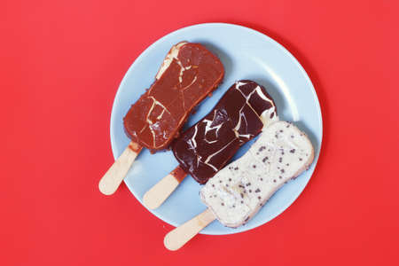 Fracture ice cream coating. Three flavors on plateの写真素材
