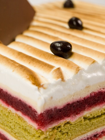 Cake pistachio, strawberries and cream close-up
