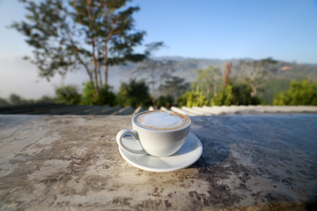 Cup of coffee on the background of the blue sky backgroundの写真素材