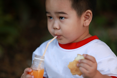 Young boy eating breadの写真素材