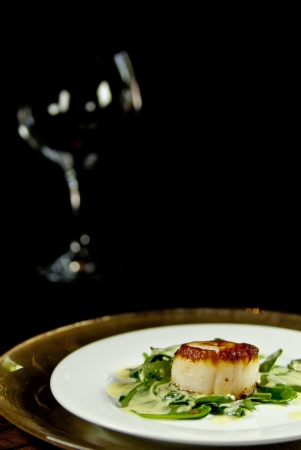 Chilean Sea Bass at the bottom right frame and an empty wine glass top left の写真素材