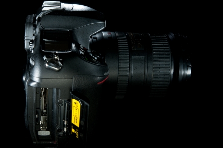 Open compact flash bay for a black DSLR profile shot