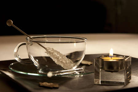 A cup and a candlelight with a sugar stickの写真素材