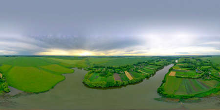 A colorful 360-degree panorama view from the air at sunset. Summer landscape of the countryside, rivers, meadows, fields.の写真素材