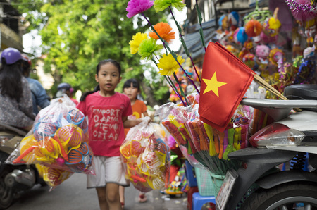 Hanoi, Vietnam - Sep 2, 2015: Vietnamese children going out to buy traditional lantern and toy on Hang Ma old street for full moon festival on lunar August.のeditorial素材