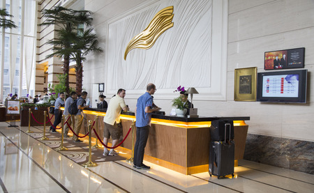 Shenzhen, China - Jun 14, 2016: Customers making check in procedure at the check in counter in lobby area of Grand Mercure Oriental Ginza Hotel.のeditorial素材