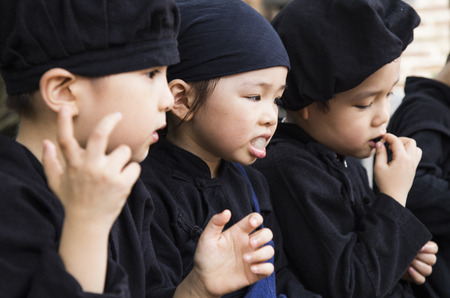 Hanoi, Vietnam - Sep 14, 2016: Vietnamese little children on traditional dresses resting while visiting Temple of Literature in Hanoi capital.のeditorial素材