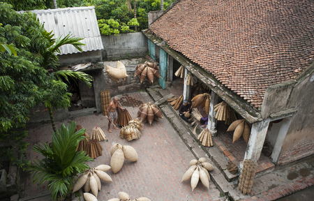 Hung Yen, Vietnam - Jul 26, 2015: Vietnamese craftsmen making bamboo handicraft products to maintain a traditional handicraft in a countryside of Vietnam.のeditorial素材