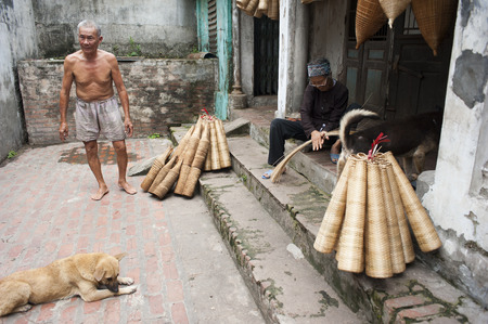 Hung Yen, Vietnam - Jul 26, 2015: Vietnamese craftsmen making bamboo handicraft products to maintain a traditional handicraft in a countryside of Vietnam.のeditorial素材