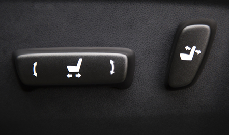 Car interior with buttons for adjusting seat position