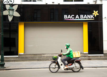 Hanoi, Vietnam - Mar 28, 2020: A Vietnamese local bank office closes on weekend to prevent the...