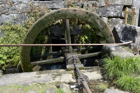 Old wooden wheel of ruined water millの写真素材