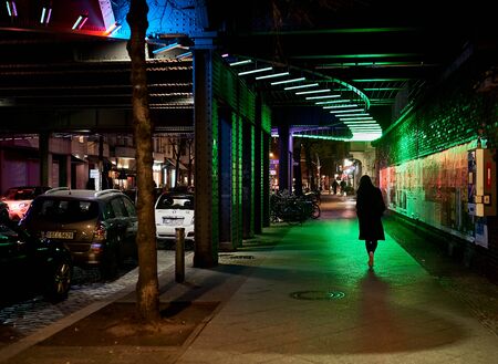 Berlin at night street woman walking aloneの写真素材
