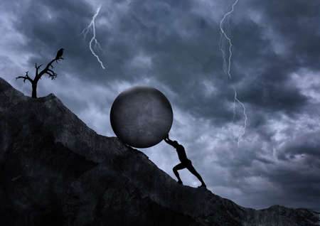 Young man pushing big rock uphill, surreal concept, challenge and hard work, strength and obstacle, difficulty and goal concepts.の写真素材