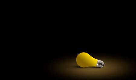 Light bulb on the ground in dark background with cinematic light. Conceptual photo with space....