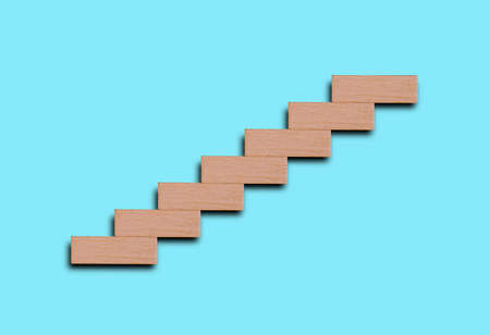 Ascending wooden stairs isolated in blue sky background
