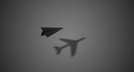single paper plane flying with big shadow on gradient grey background, self-path, self-fight, self-dreams concept, illustration with copy space and top viewの写真素材